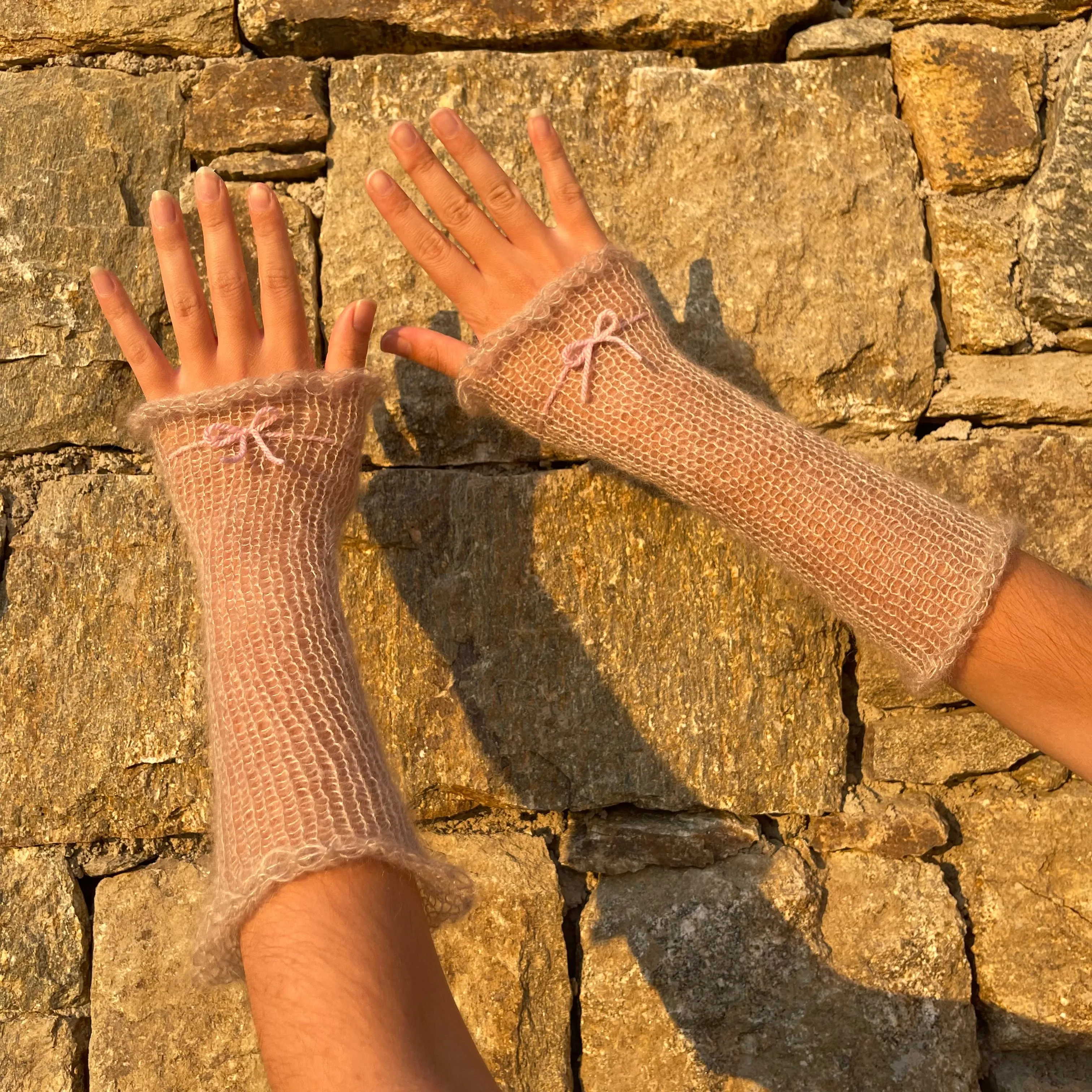 Handmade knitted mohair hand warmers in beige with dusky pink bow