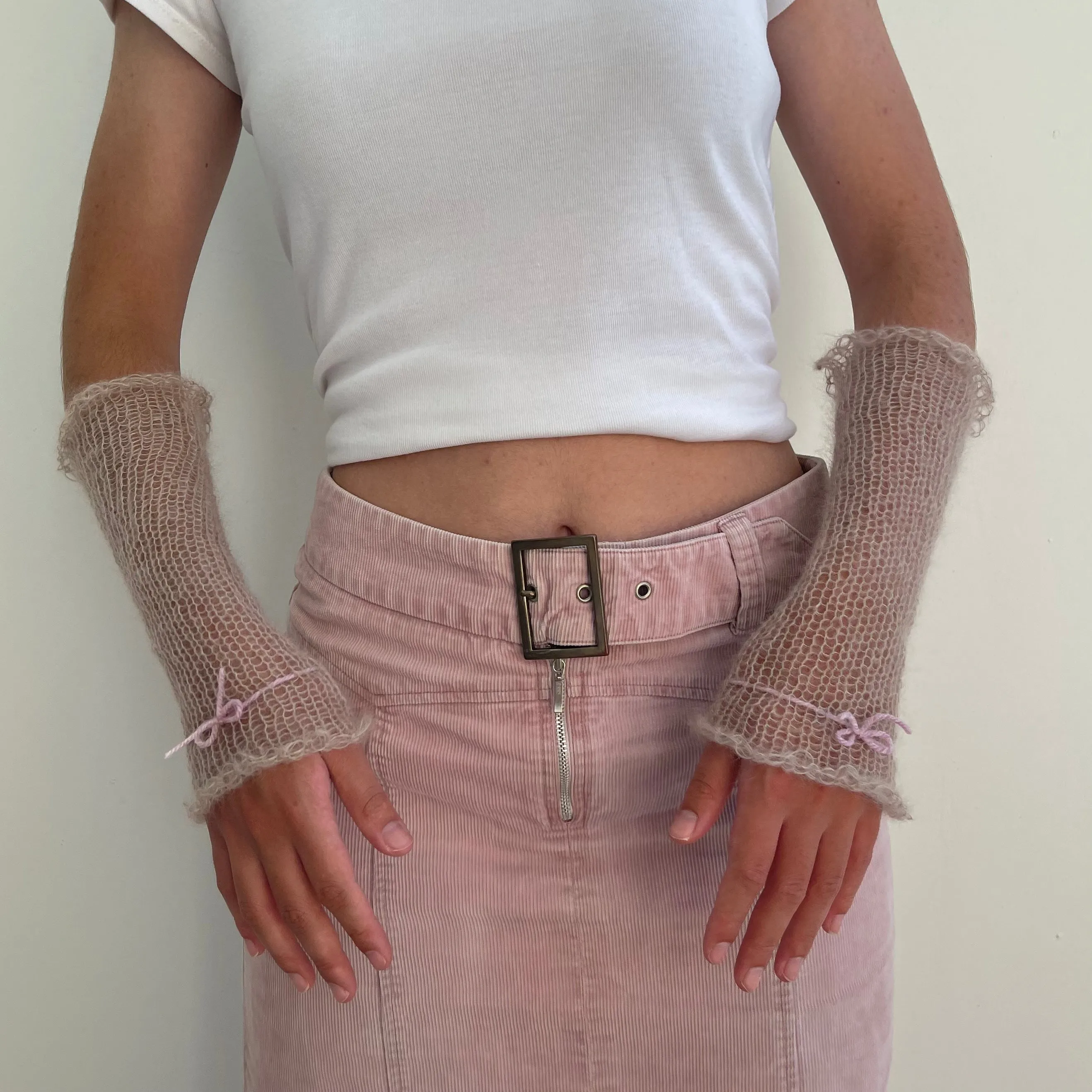 Handmade knitted mohair hand warmers in beige with dusky pink bow