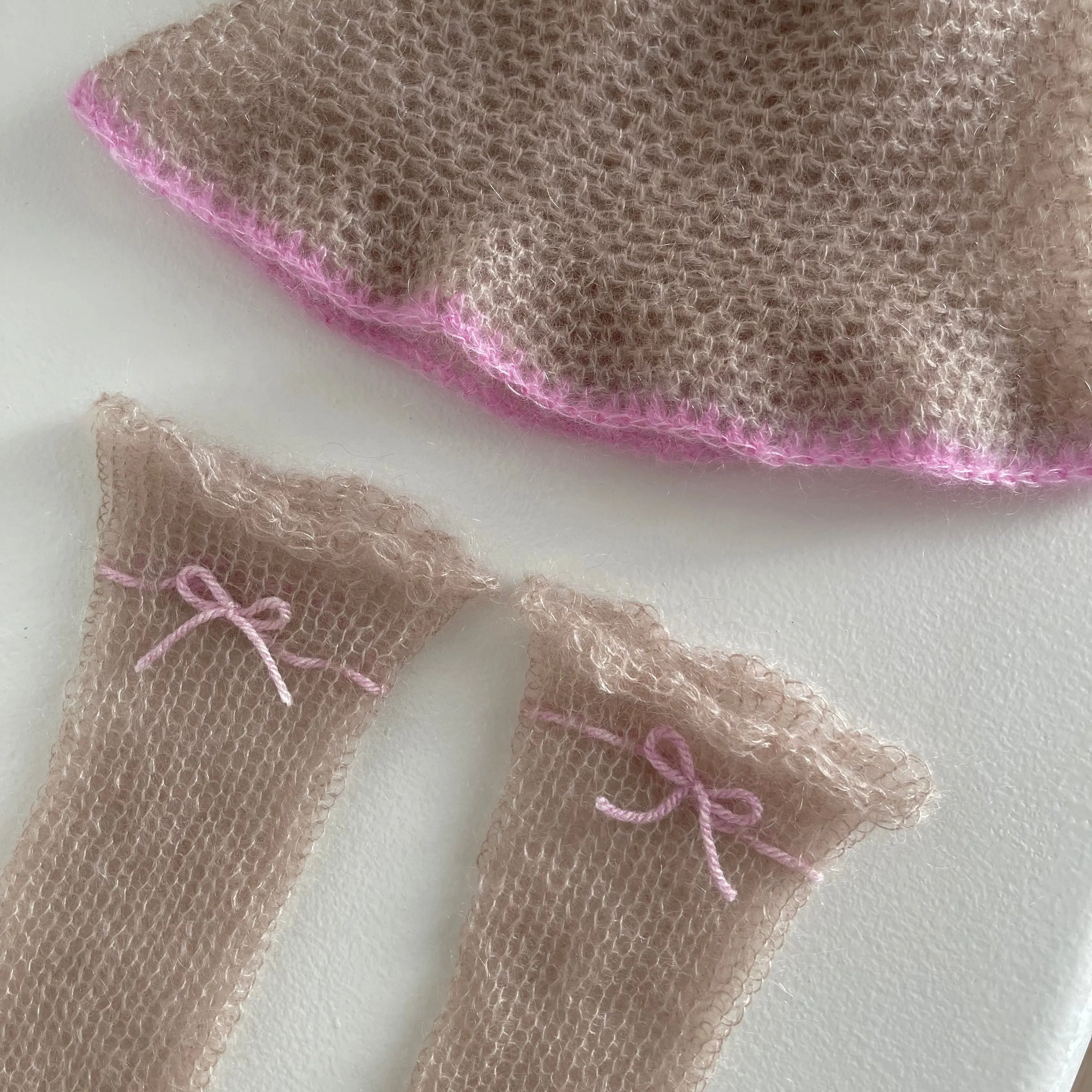 Handmade knitted mohair hand warmers in beige with dusky pink bow